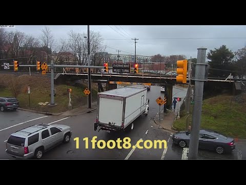 Pedestrian dodges truck crash debris at the 11foot8 bridge