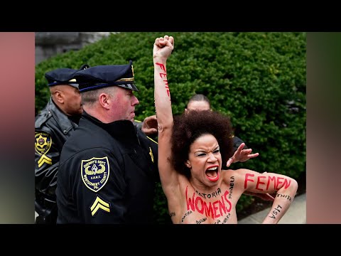 Topless Woman Charges Bill Cosby at Retrial