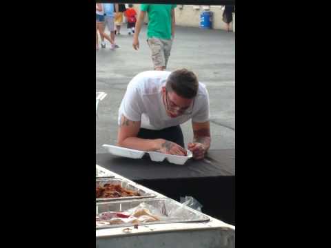 Drunk guy eating pulled pork sandwich